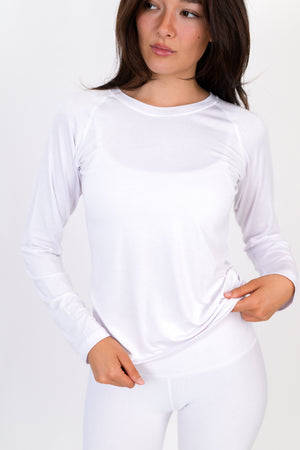 White long-sleeve crewneck shirt, front close-up with smooth fabric and small chest emblem.