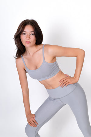 Gray form sports bra with thin straps and racerback styling, side view