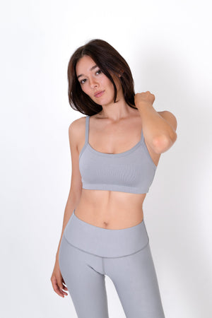 Gray sports bra with thin straps and scoop neckline, front view