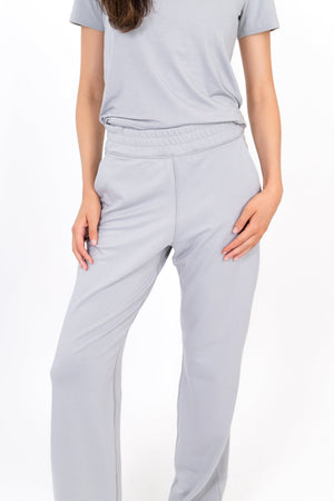 Light gray wide-leg sweatpants with side pockets and relaxed straight legs