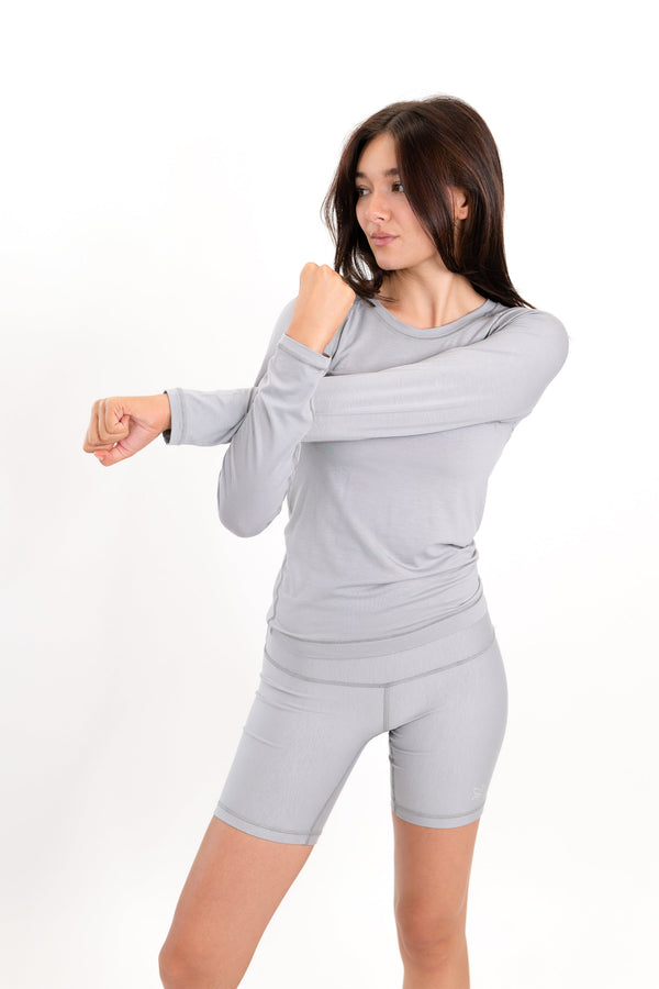 Gray 5-inch core shorts in side view, fitted silhouette and logo on left leg.