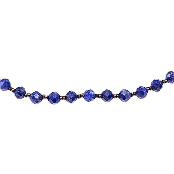 Blue faceted lapis bead necklace detail of round faceted beads with gold-tone spacers