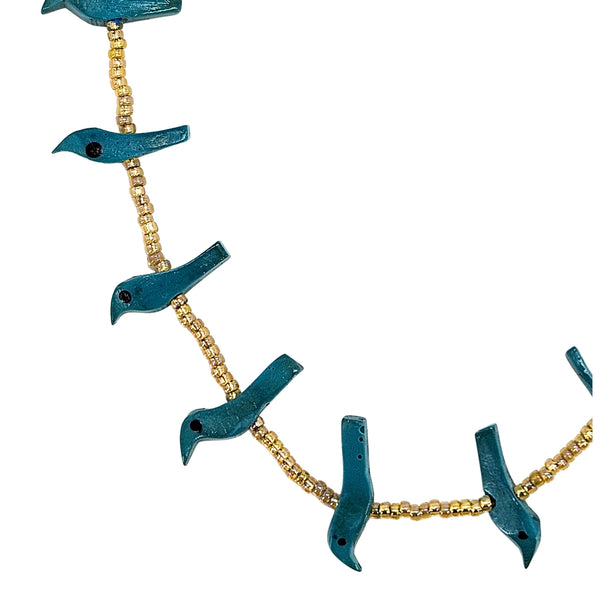 Close-up teal bird charm bead necklace with gold-tone bead chain