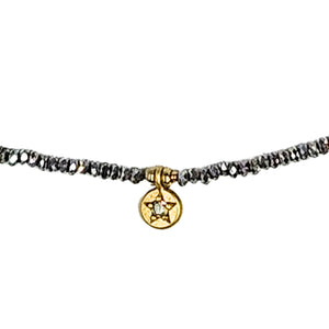 Grey faceted beaded strand necklace with gold star coin charm detail