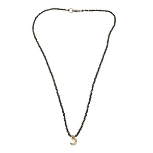 Black micro-bead choker with small gold moon charm and adjustable back chain