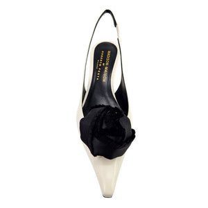 Beige leather slingback kitten heel with black flower accent at the back
