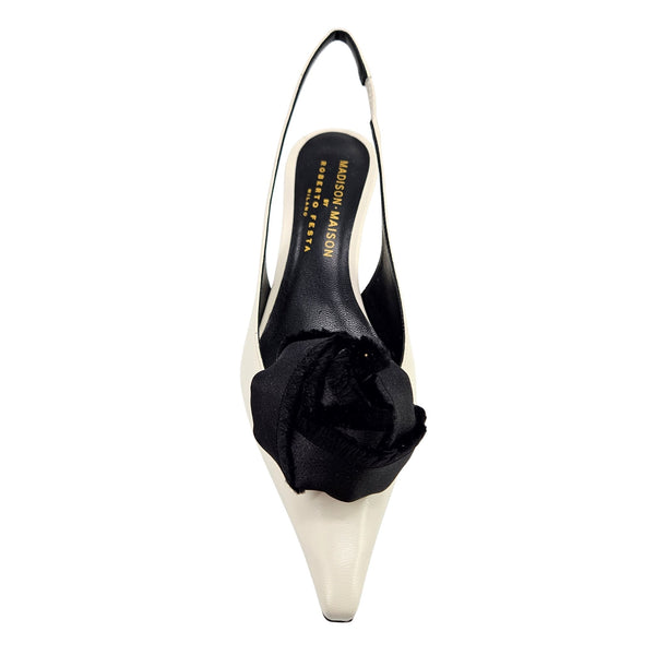 Beige leather slingback kitten heel with black flower accent at the back