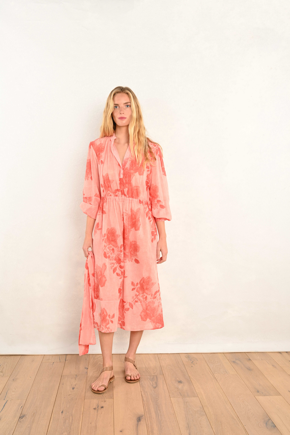 Coral pink floral midi dress with V-neck, long sleeves, and elastic waist.