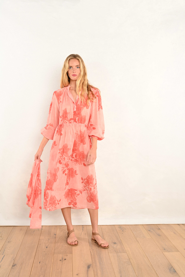 Coral pink floral midi dress with V-neck, long sleeves, and elastic waist.