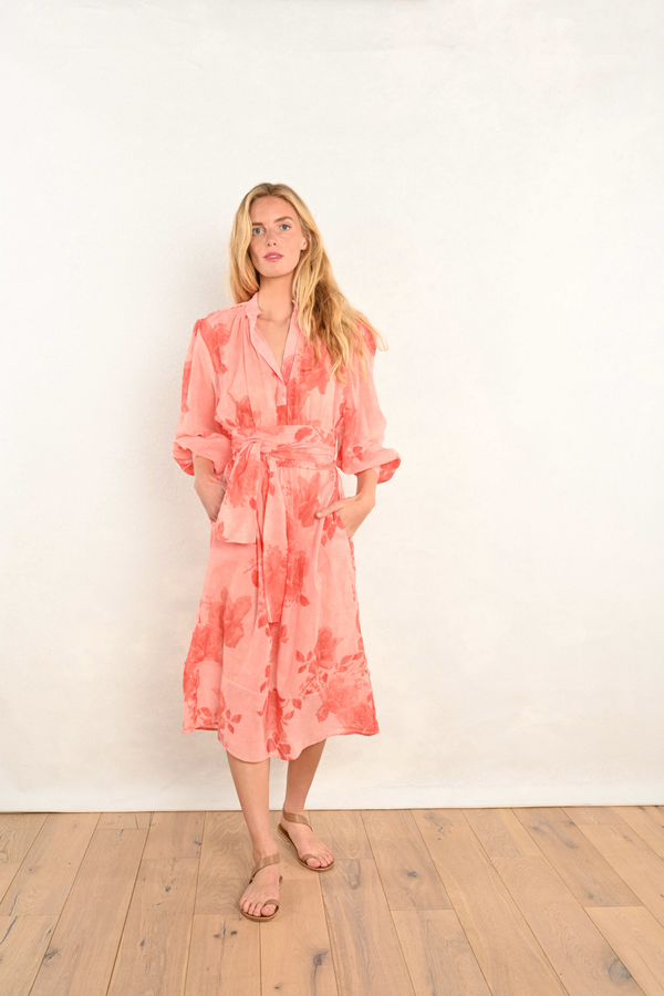 Coral pink floral midi dress with V-neckline, three-quarter-long billowy sleeves.