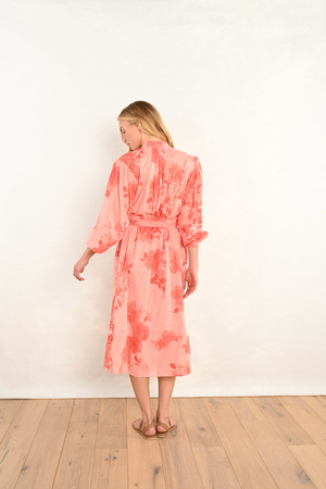Coral pink floral midi dress, side view; V-neck with belted waist and long sleeves.