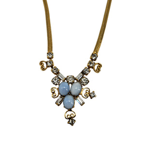 Gold-tone rhinestone necklace with blue teardrop center pendant and ornate links