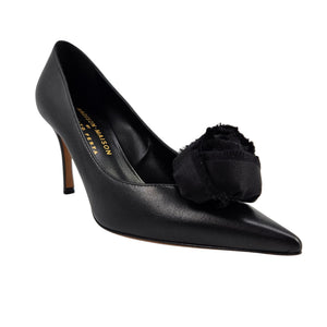 Black leather pointed-toe heel pump with large fabric flower detail at the front.