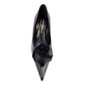 Black leather heel pump with pointed toe and flower embellishment