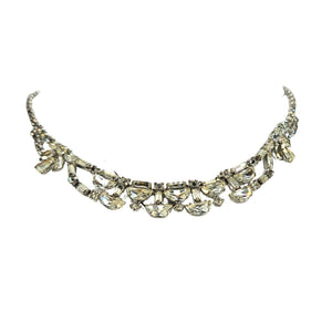 Silver rhinestone necklace with scalloped teardrop center rows and ribbon bow accents