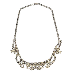 Silver rhinestone necklace with curved rows and bow-like side accents