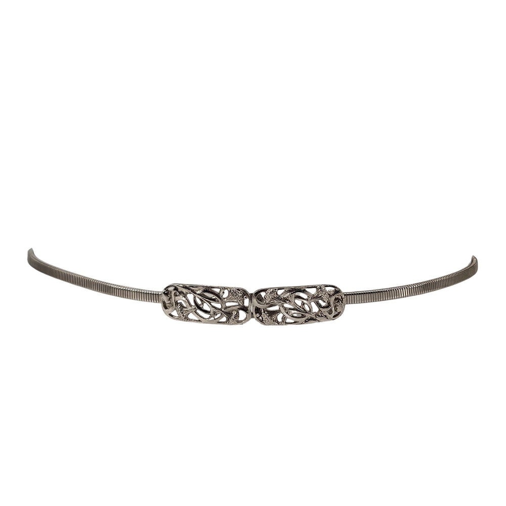 Silver stretch belt with ornate floral filigree buckle center