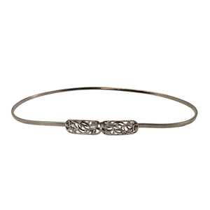 Silver stretch belt with ornate floral filigree buckle center