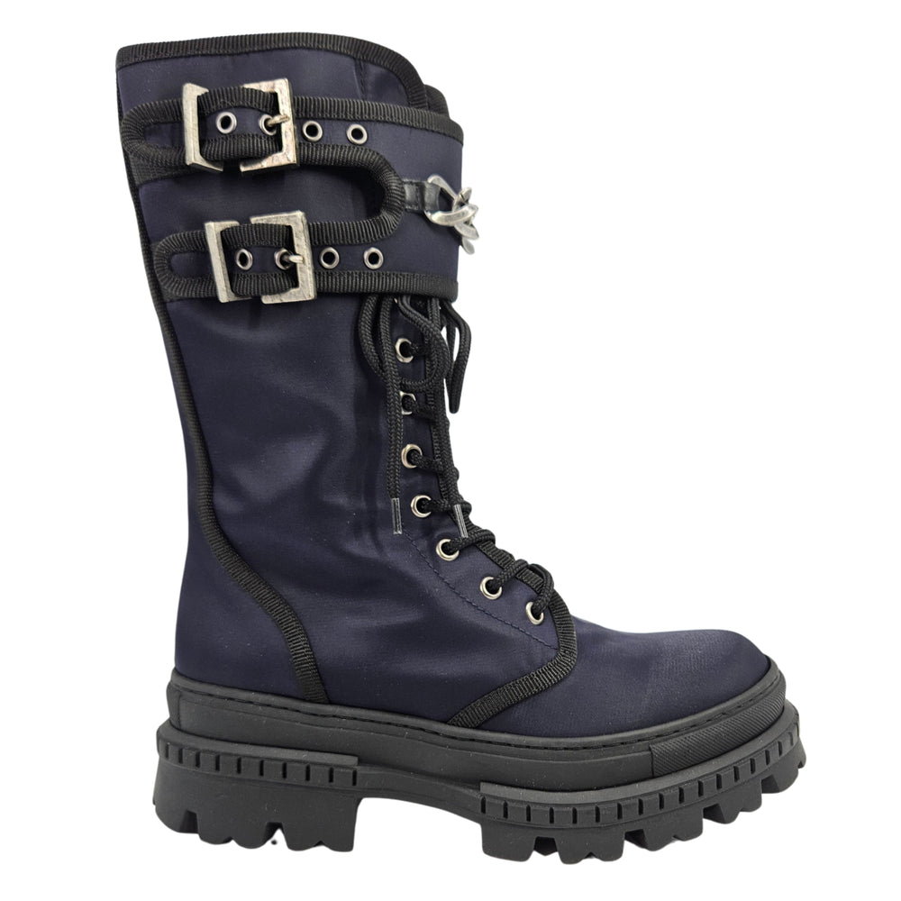 Navy lace-up combat boot with buckled strap and metal chain detail, lug sole