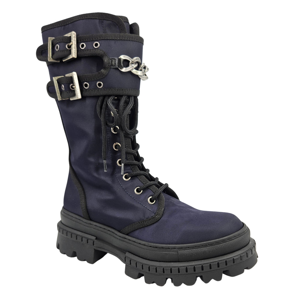 Navy lace-up combat boot with buckled strap and metal chain detail, lug sole