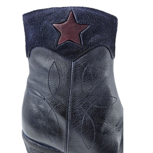Navy leather ankle boot close-up with star patch on front shaft, textured finish