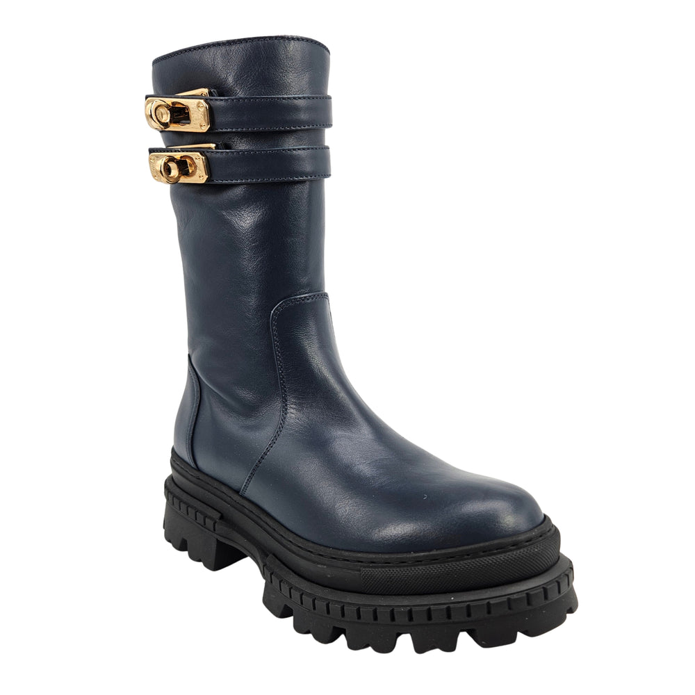 Navy shearling-lined platform boots with two gold buckle straps and chunky tread sole