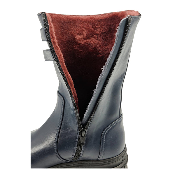 Navy shearling-lined platform boots showing dark brown shearling interior through zipper