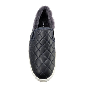 Navy quilted leather slip-on sneaker with gray shearling interior collar, white sole