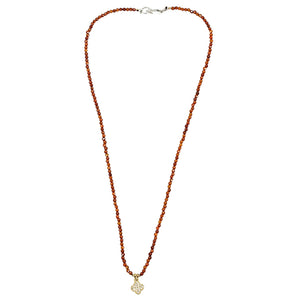 Long orange faceted bead necklace with clover charm pendant and silver clasp at back