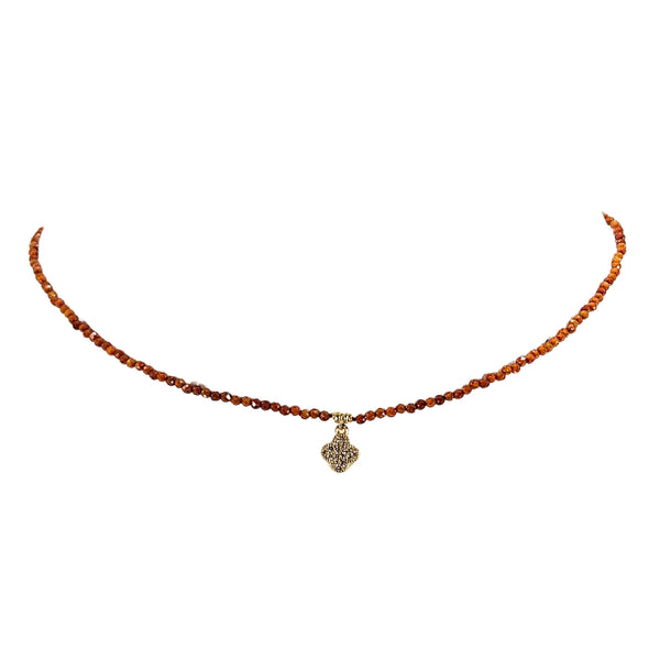 Orange beaded choker necklace with faceted beads and clover charm, silver-tone detail