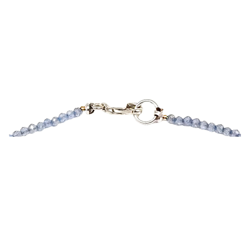 Charm necklace with pale violet blue beaded strand and gold-toned flower pendant