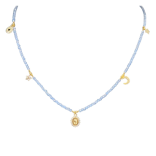 Charm necklace close-up with pale violet blue beads and small gold charms along chain