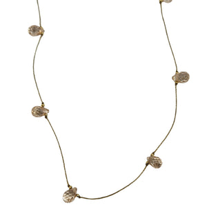 Gold-tone delicate necklace with peach teardrop faceted gemstones on thin chain