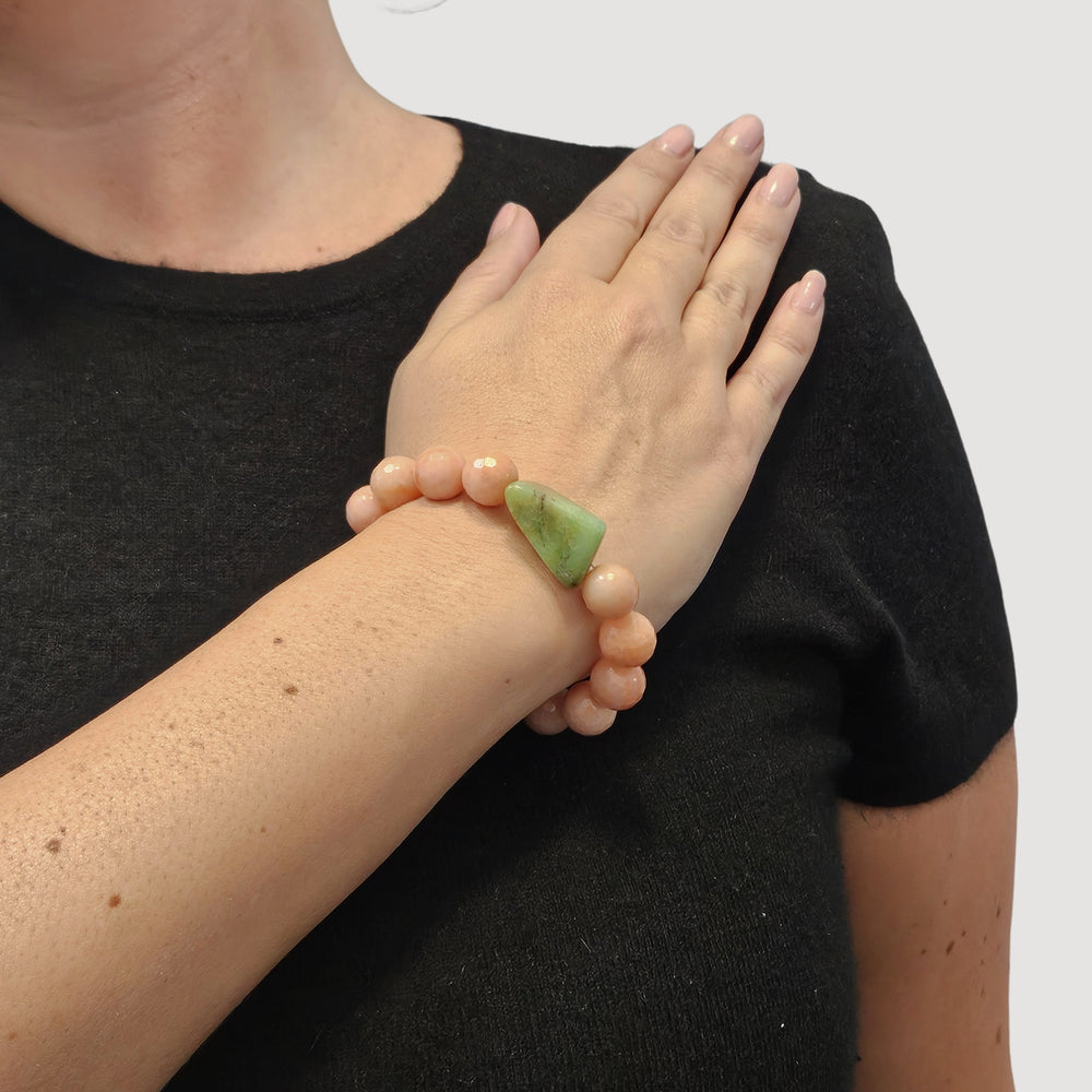 Peach-pink beaded stretch bracelet with green stone and pearl charm