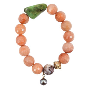 Peach bead stretch bracelet with faceted stone triangle and dangling dark charm