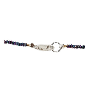 Beaded necklace with lobster clasp and ring closure on a multicolor strand