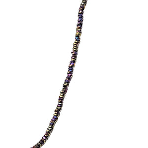 Close view of dark multicolor beaded strand choker with gold-toned spacers along the chain
