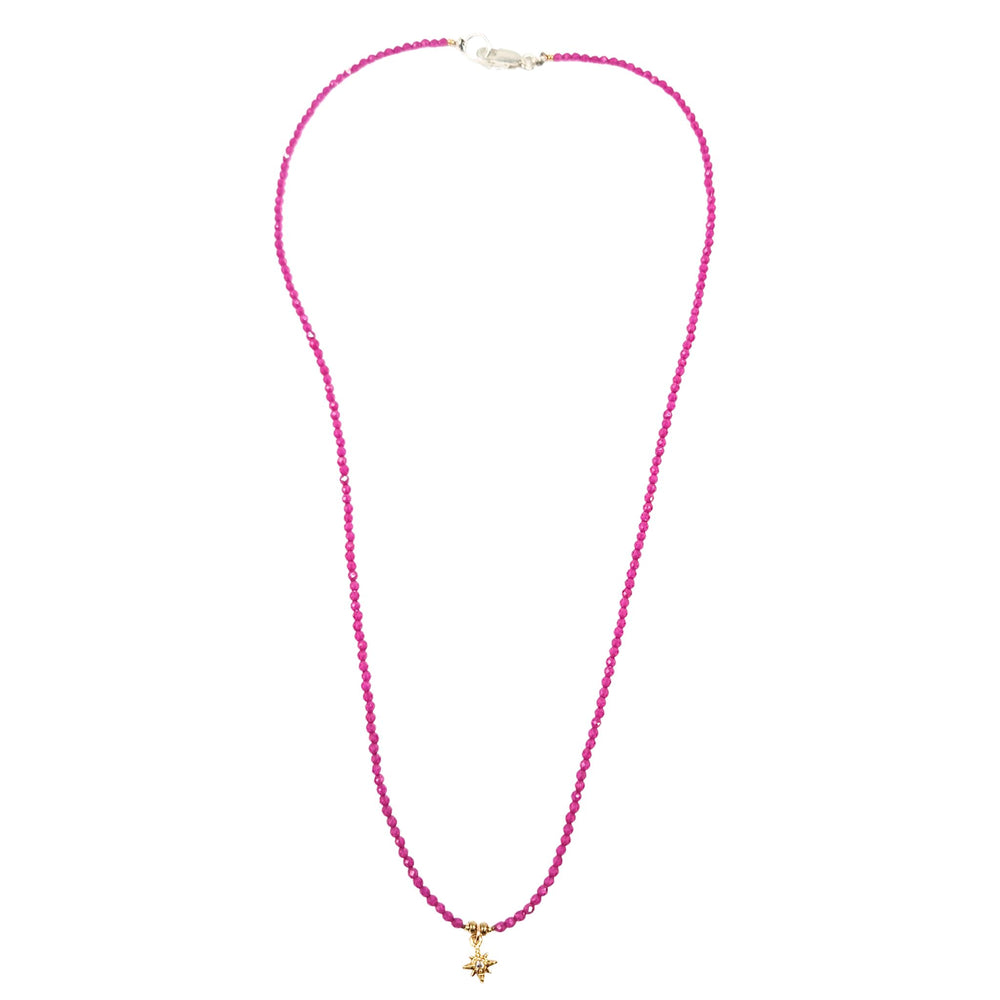 Pink beaded necklace with gold star charm and small bead accents