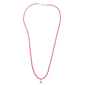 Pink beaded necklace with gold star charm and small bead accents