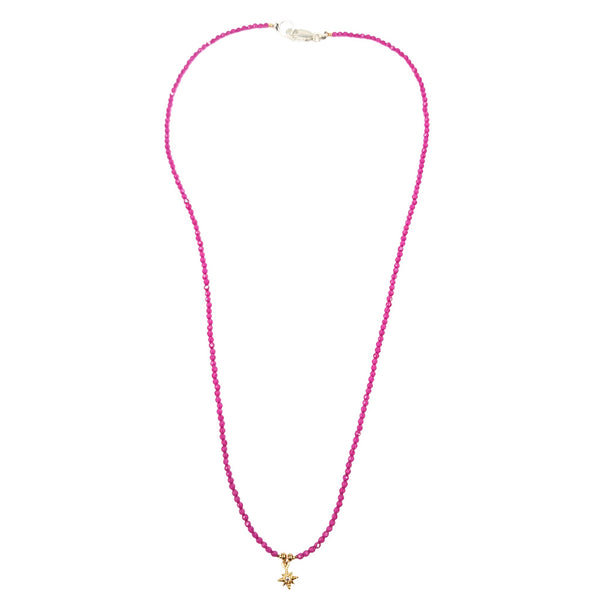 Pink beaded necklace with gold star charm and small bead accents