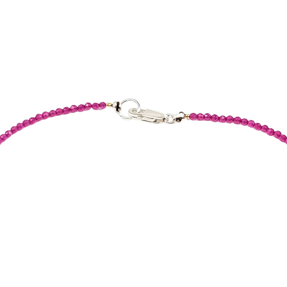 Pink beaded necklace with gold star charm and small bead accents