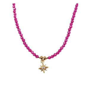 Pink beaded necklace with gold star pendant at center