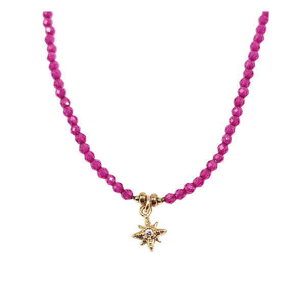Pink beaded necklace with gold star pendant at center