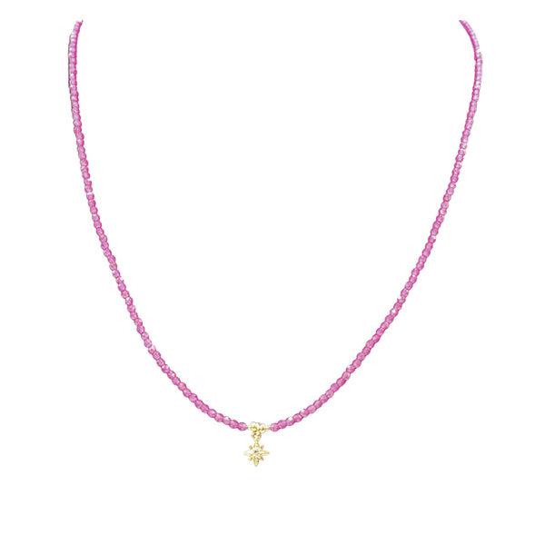 Light pink beaded necklace with small gold star charm at center