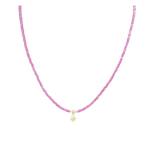 Pink beaded necklace with gold star charm centered on the strand