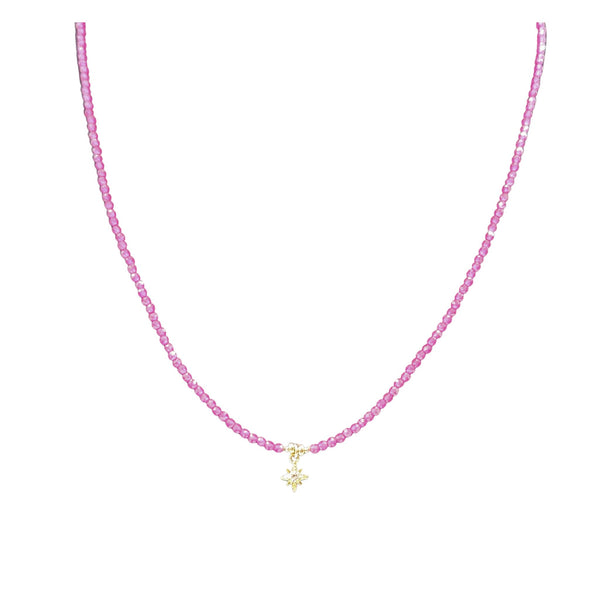 Pink beaded necklace with gold star charm centered on the strand