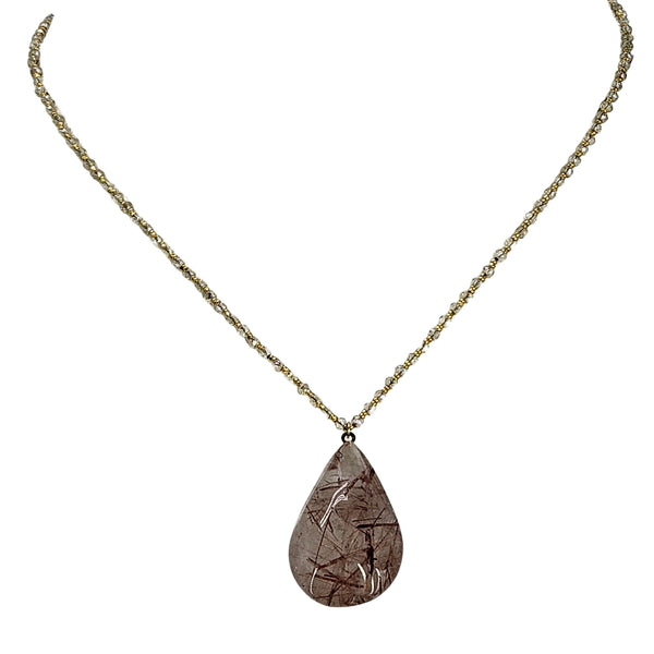 Brown rutilated teardrop gemstone pendant with gold-tone chain neckline