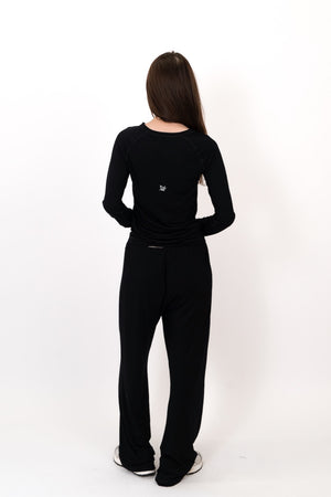 Black flow pants from back view, full length with elastic waist