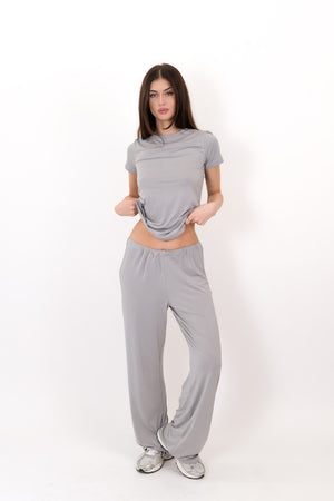 Grey flow pants on model, full-length view with relaxed straight wide-leg style