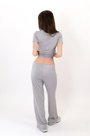 Grey flow pants from back view, full length with elastic waist